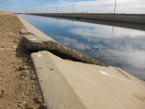 U.S. Geological Survey scientists say cracks and buckles along the Delta-Mendota Canal are likely caused by subsidence from groundwater overdraft. Photo by Amy Quinton, Capital Public Radio, November. 2013 by Amy Quinton, Capital Public Radio